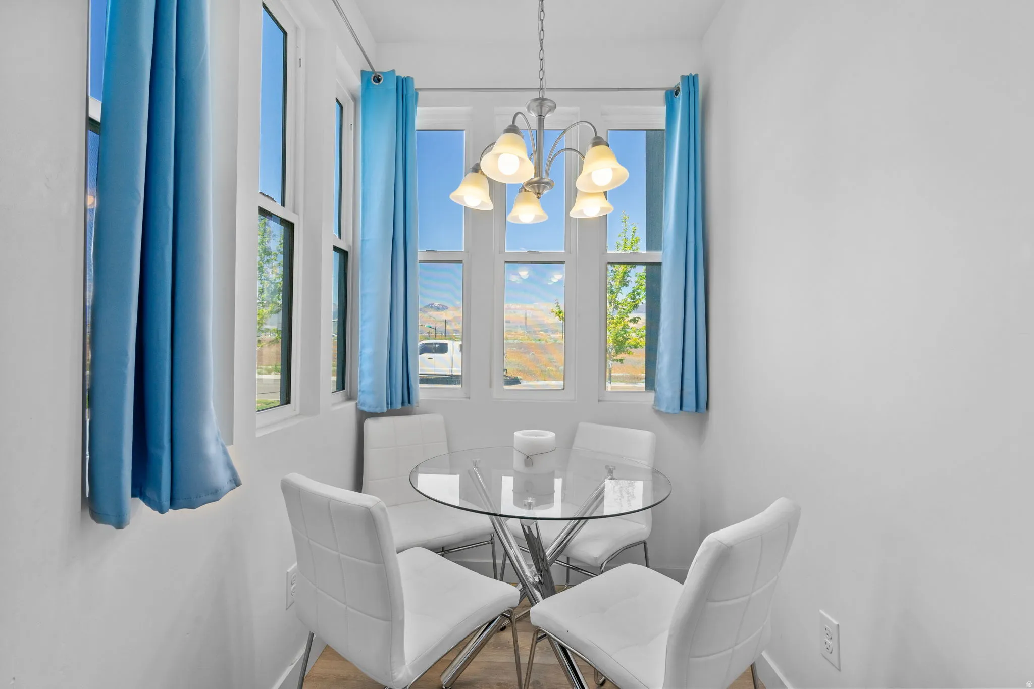 Dining space with hanging lights and wood finished floors