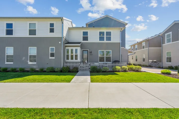 Traditional-style house featuring stucco siding and a porch