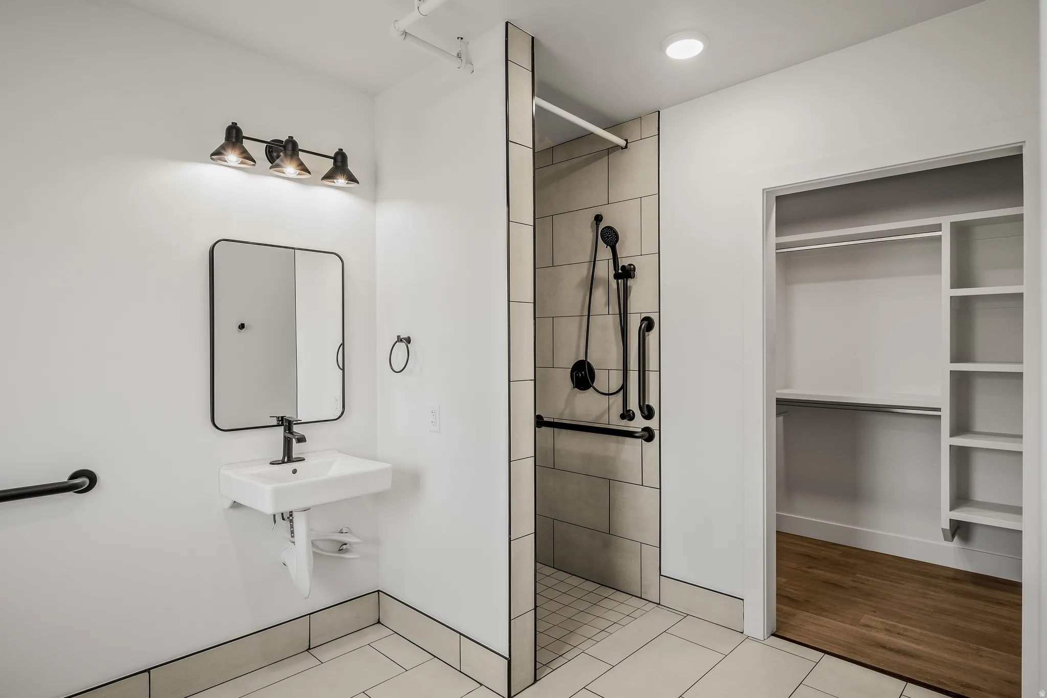 Full bath with tiled shower and light tile patterned floors