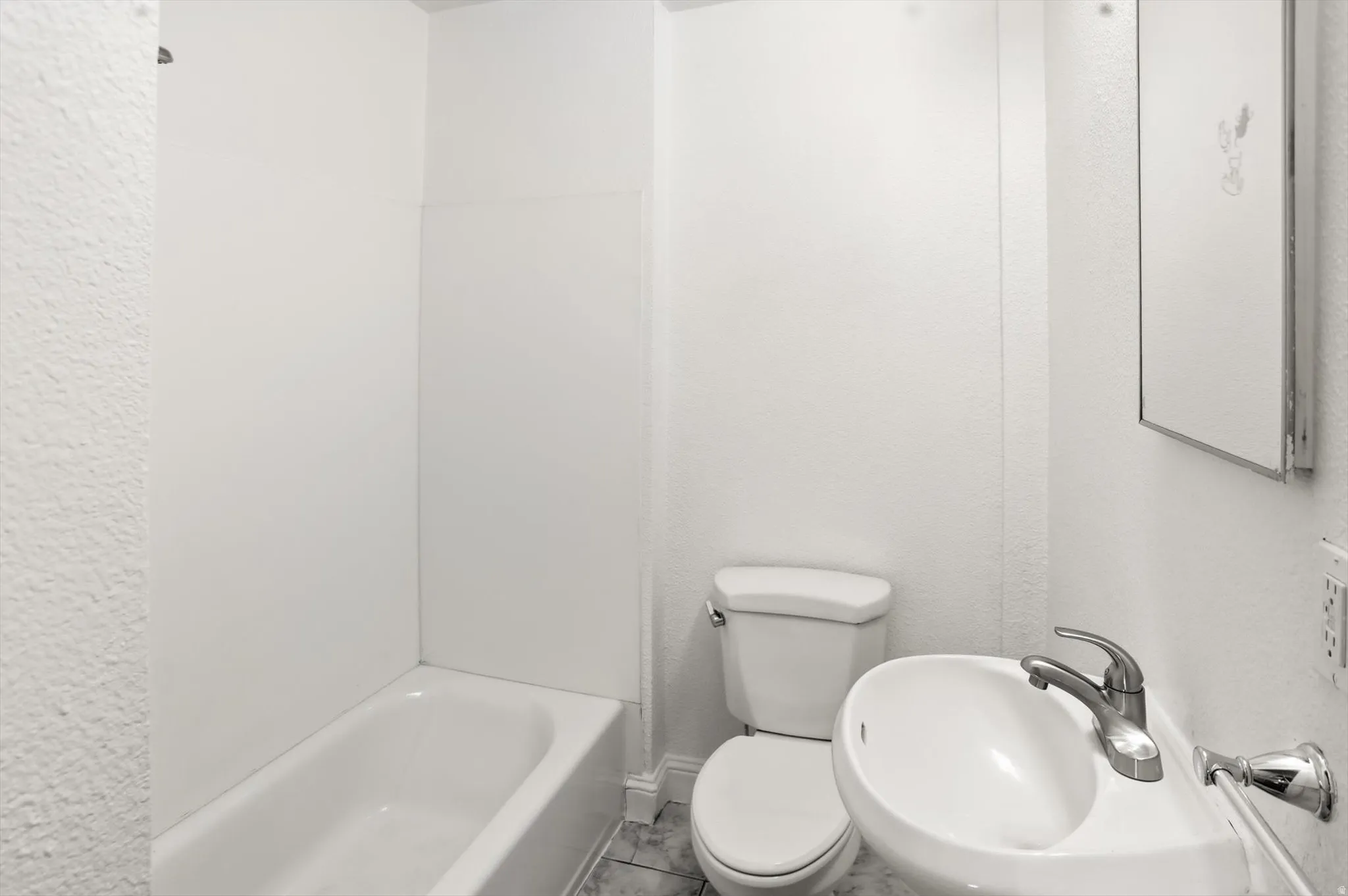 Full bath featuring toilet and a sink