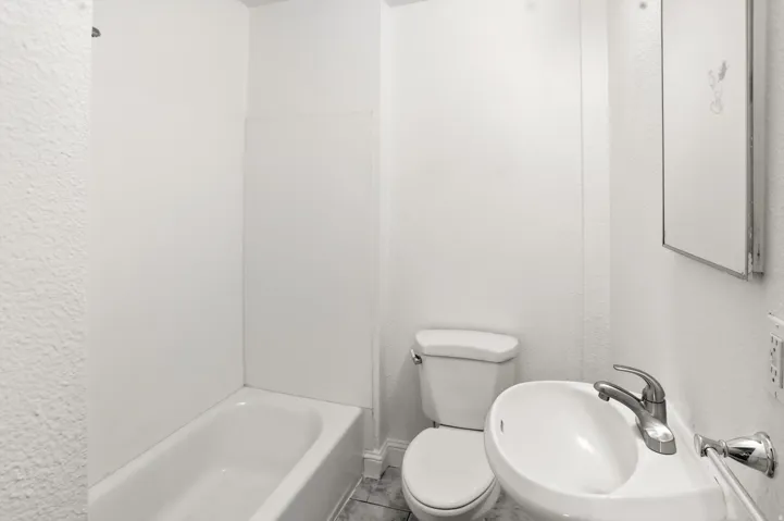 Full bath featuring toilet and a sink
