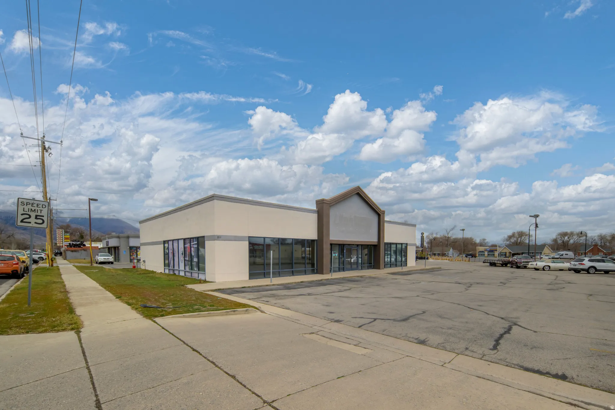 View of commercial property featuring uncovered parking