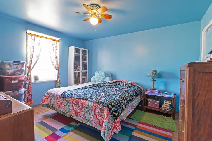 Bedroom with ceiling fan and wood finished floors