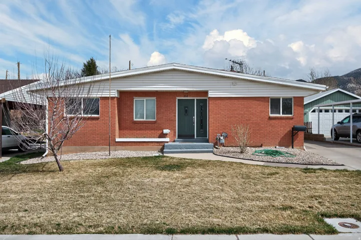 View of front of home featuring a front lawn and brick siding