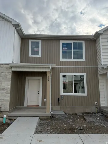 View of exterior entry featuring stone siding