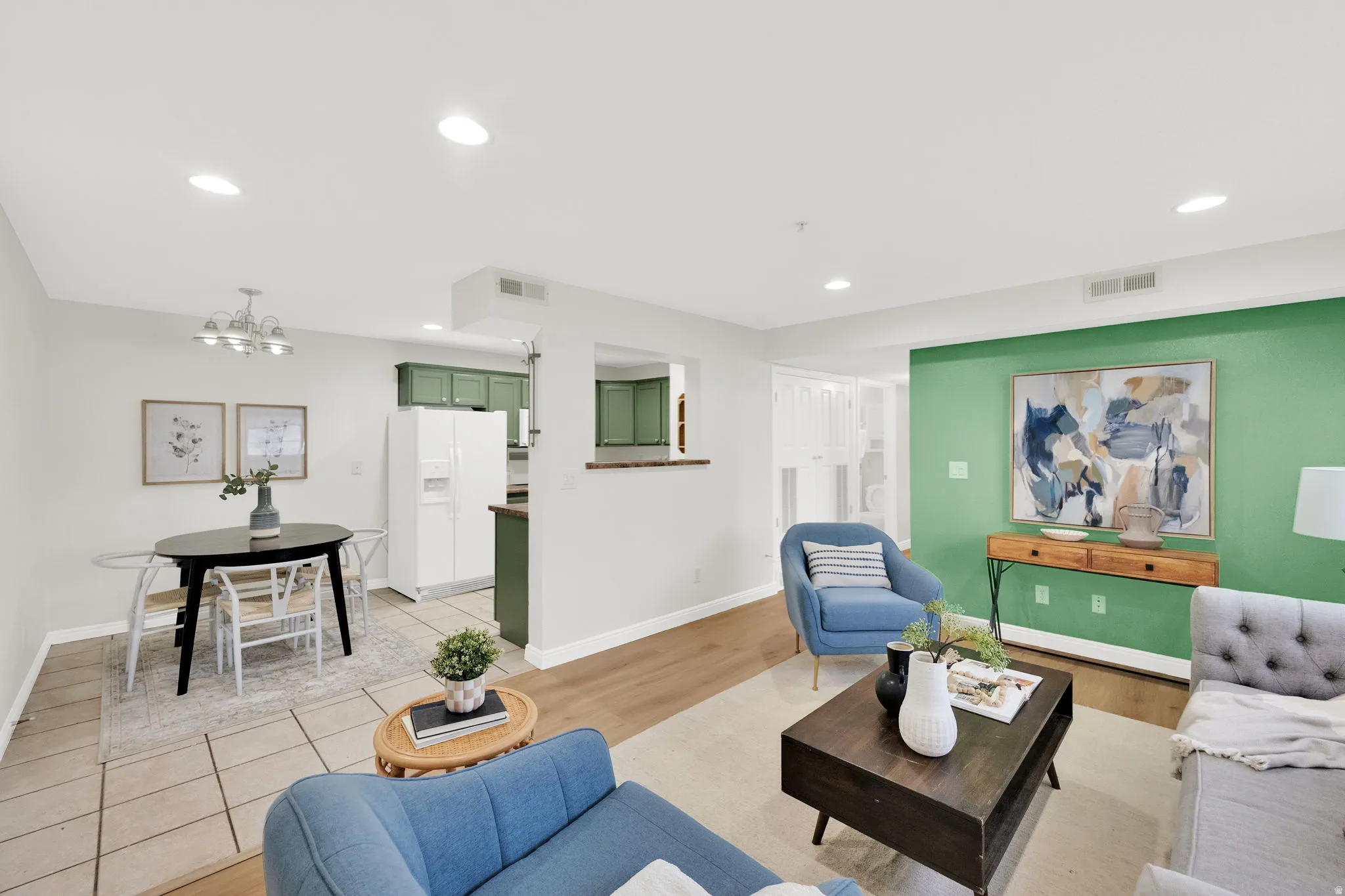 Living area featuring light wood-type flooring and a chandelier