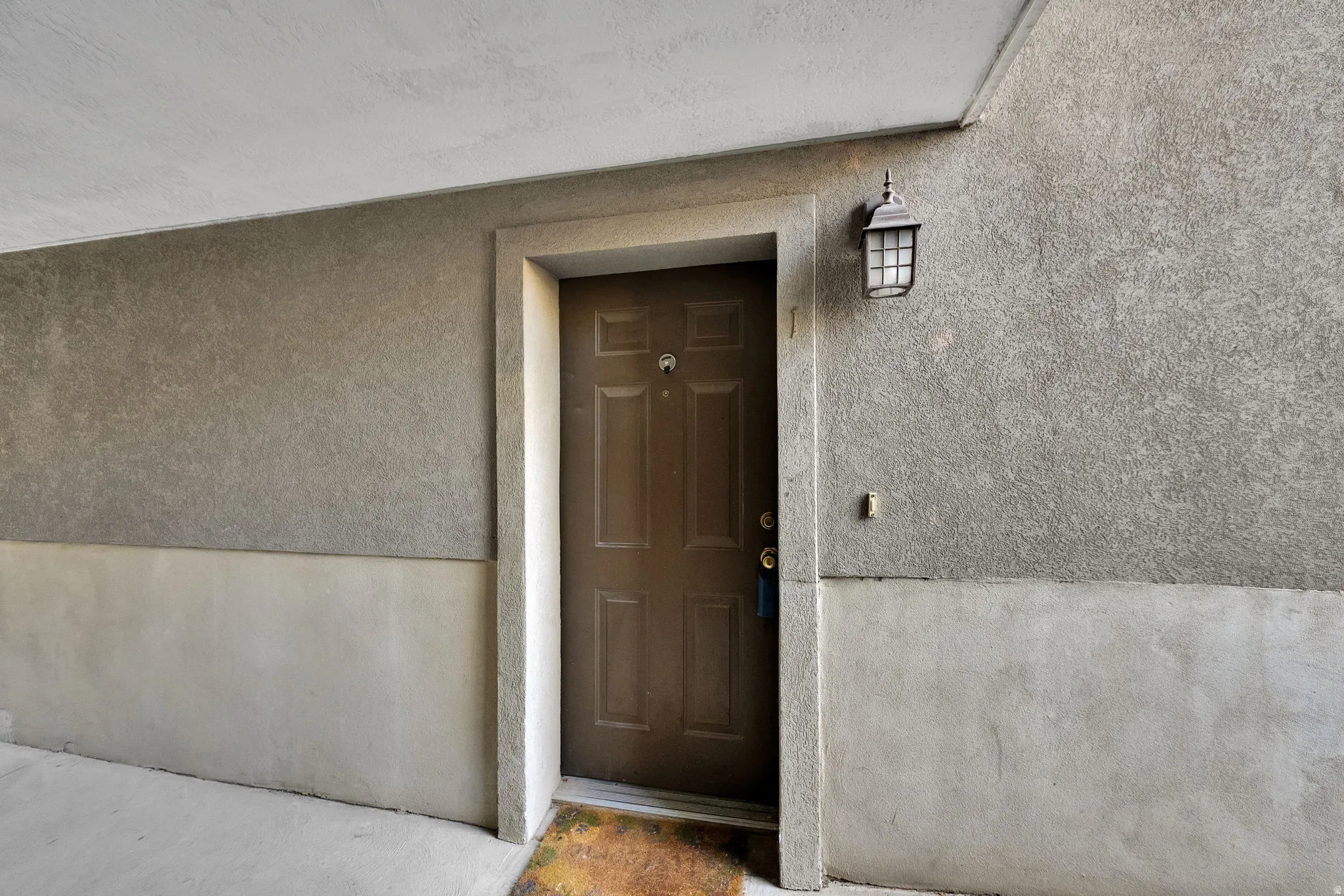 View of exterior entry with stucco siding