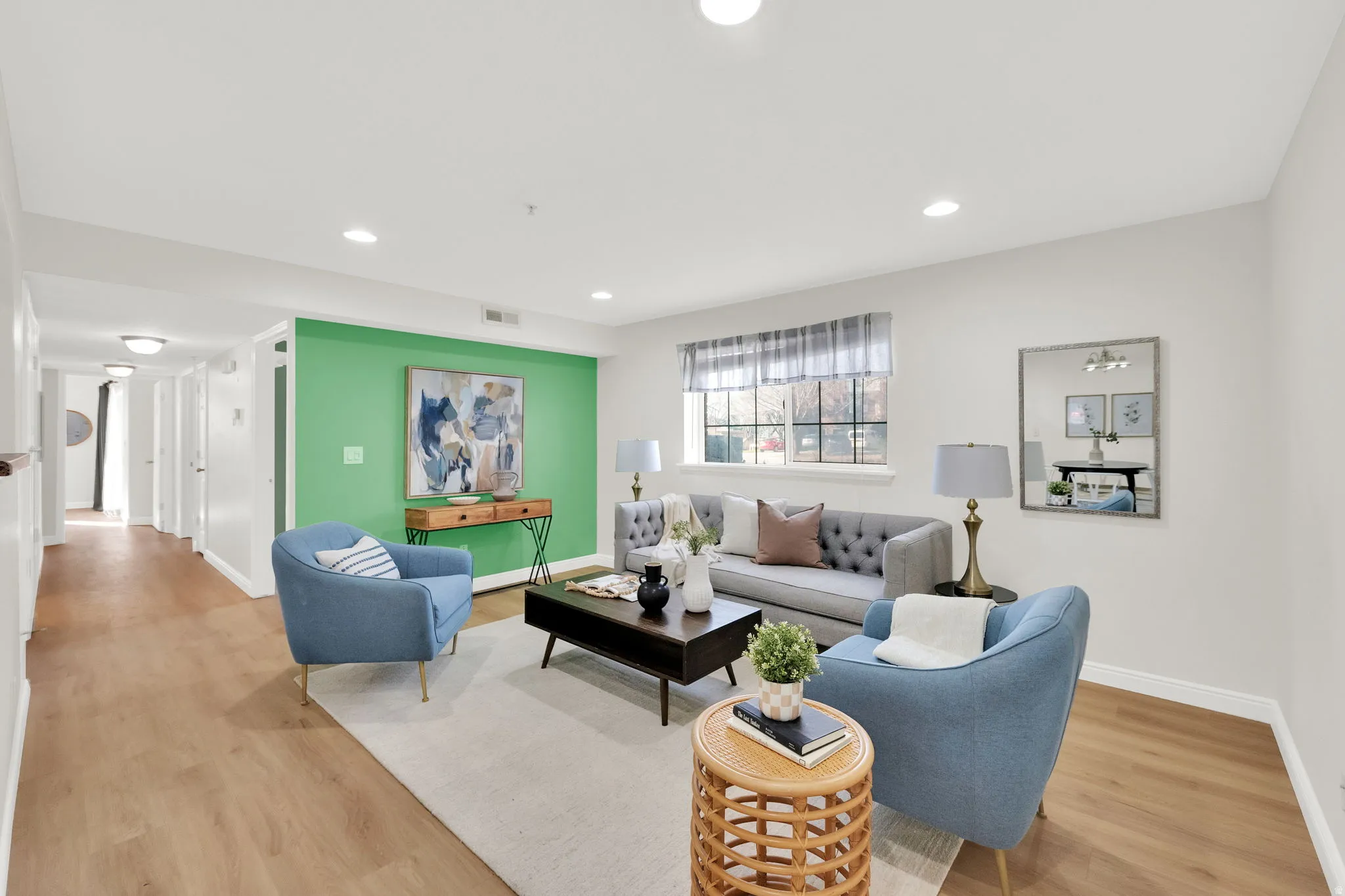 Living area featuring light wood-type flooring and recessed lighting