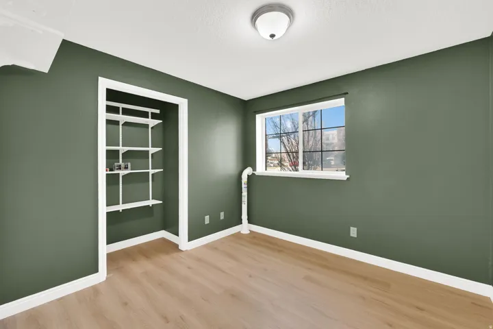Spare room featuring light wood finished floors and a textured ceiling