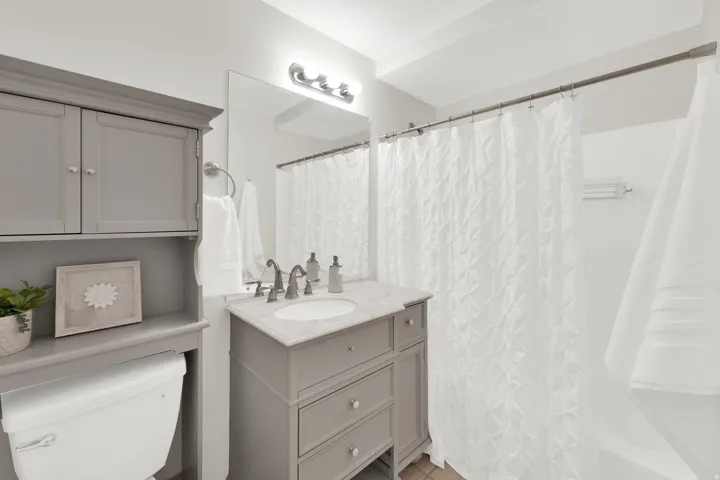 Bathroom with vanity and curtained shower
