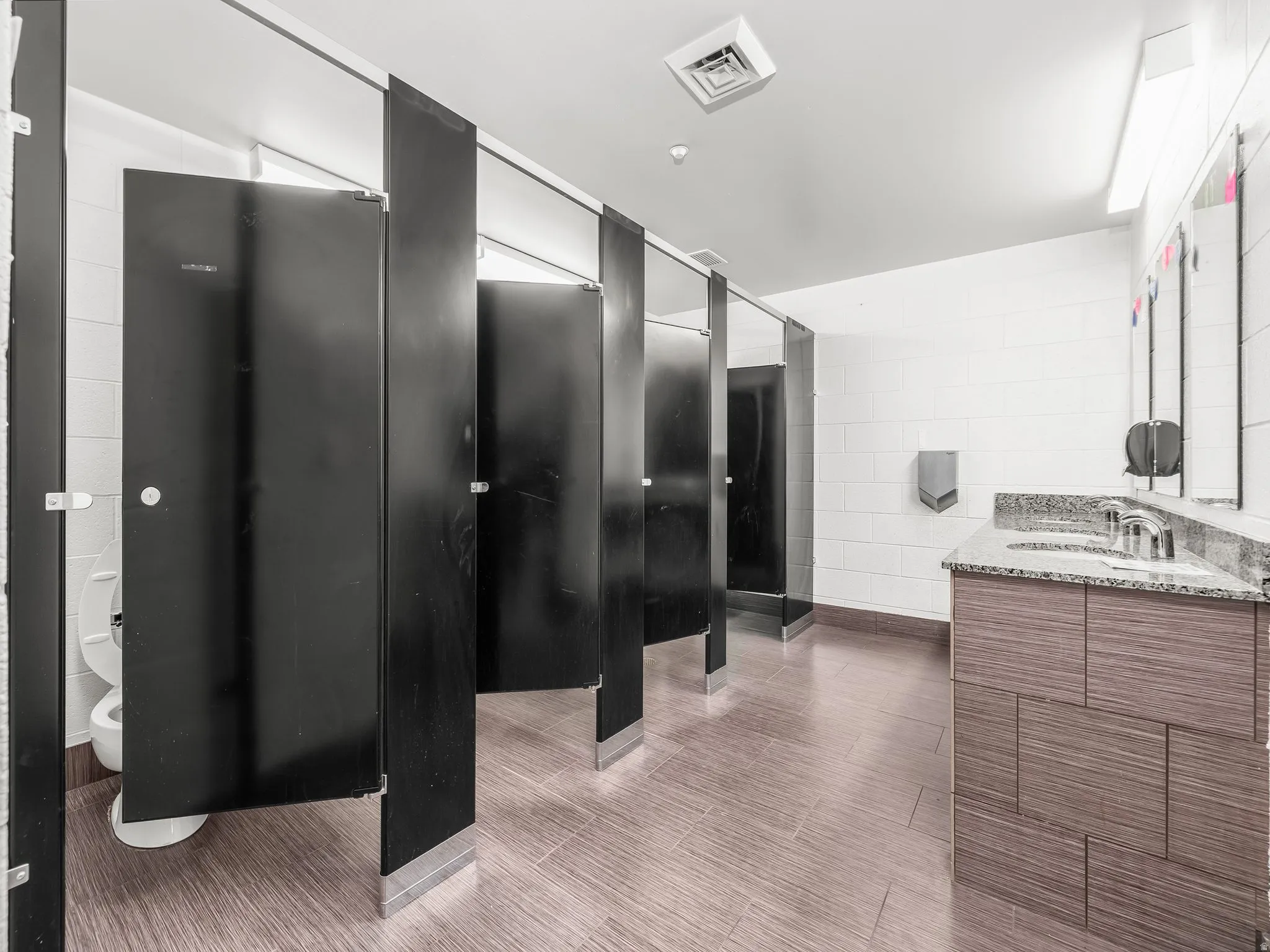 Bathroom featuring vanity and tile walls