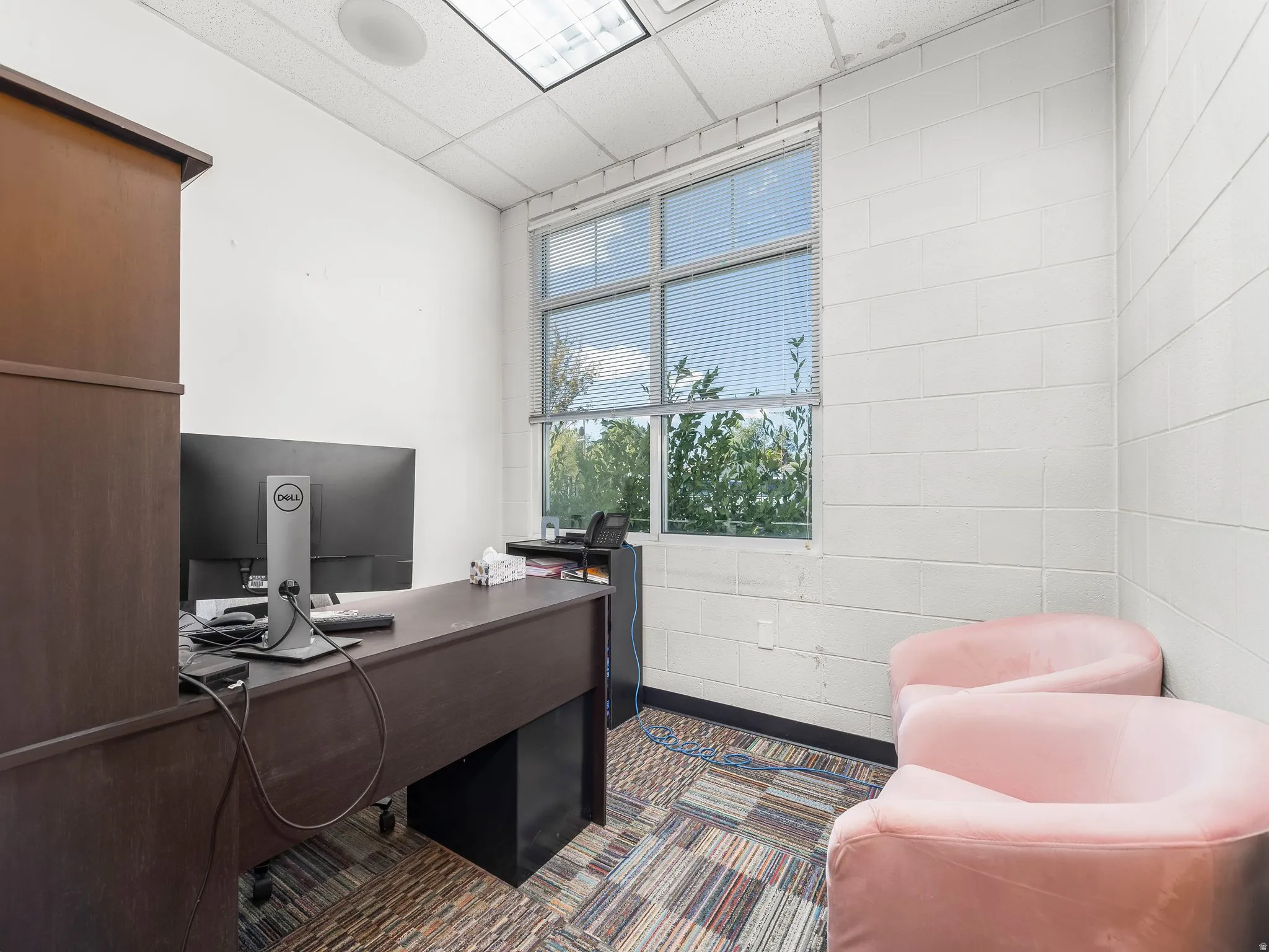 Office space with a paneled ceiling