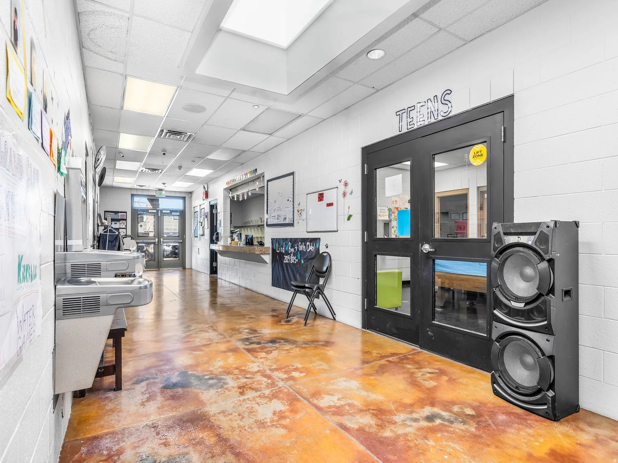 Reception area featuring a paneled ceiling, a skylight, and washer / clothes dryer