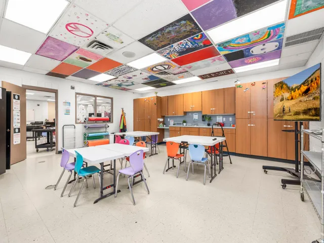 Dining space featuring light flooring and a drop ceiling