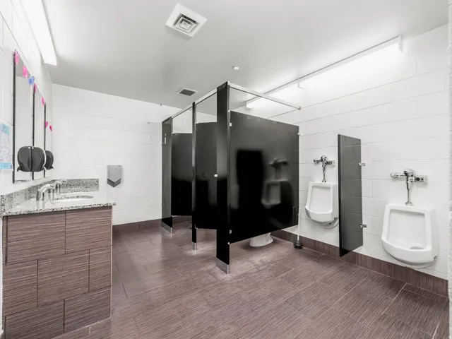 Bathroom with tile walls and concrete block wall