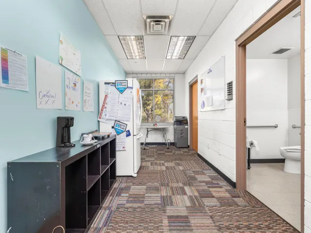 Hallway featuring a drop ceiling