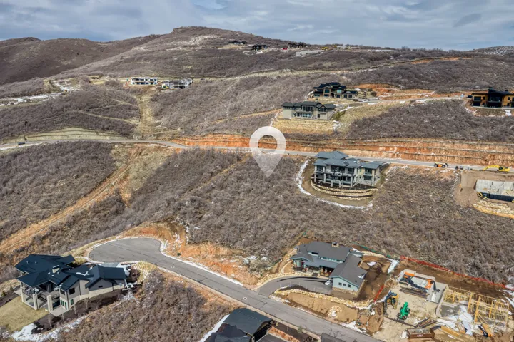 Aerial overview of property's location featuring a mountain backdrop