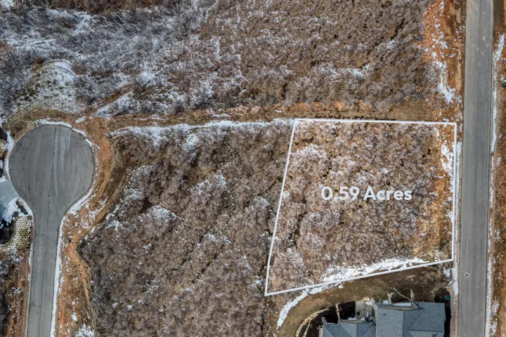 Snowy aerial view with property parcel outlined