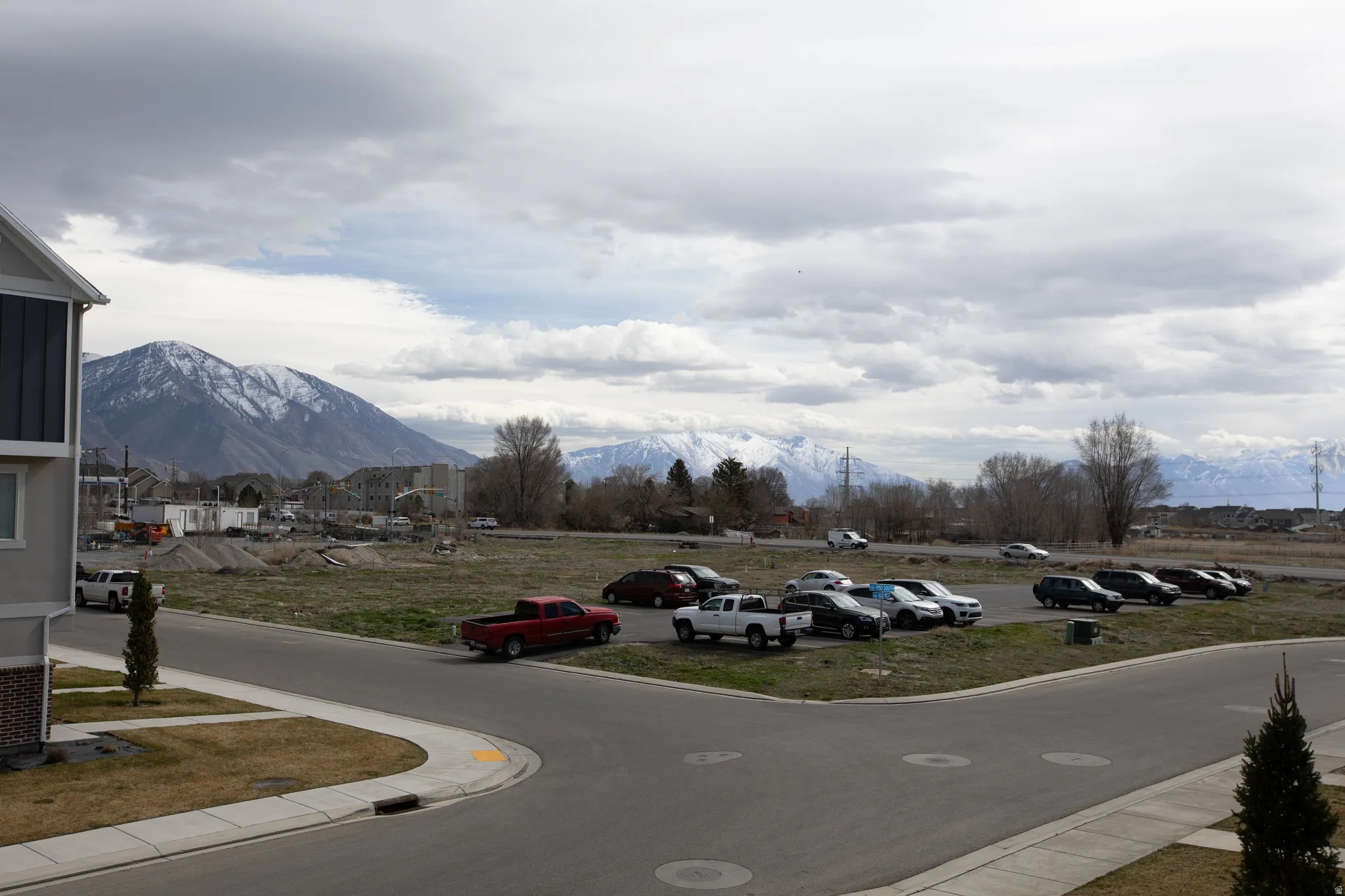 View of asphalt road with a mountain view and curbs