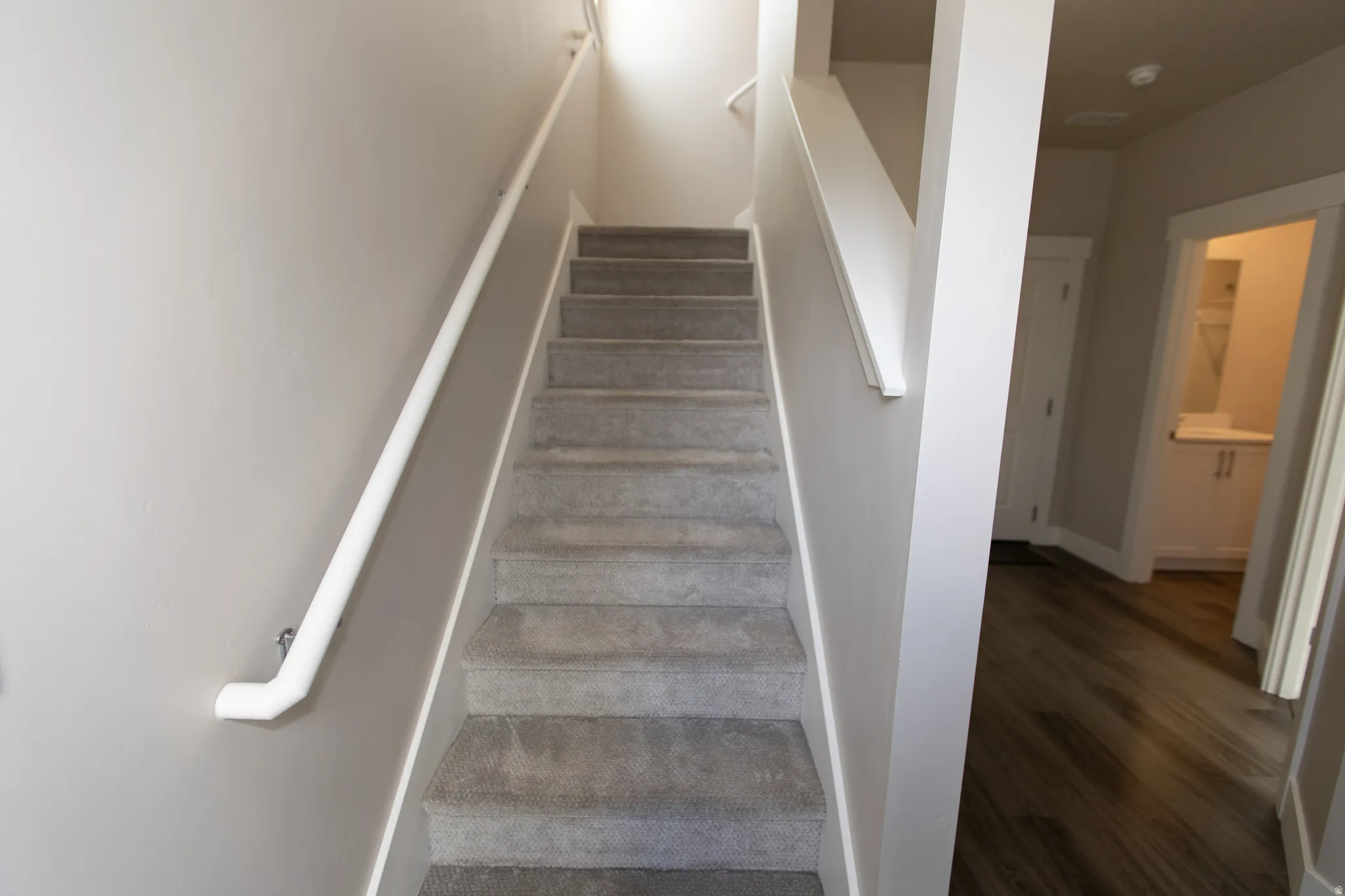 Stairway featuring wood finished floors and baseboards
