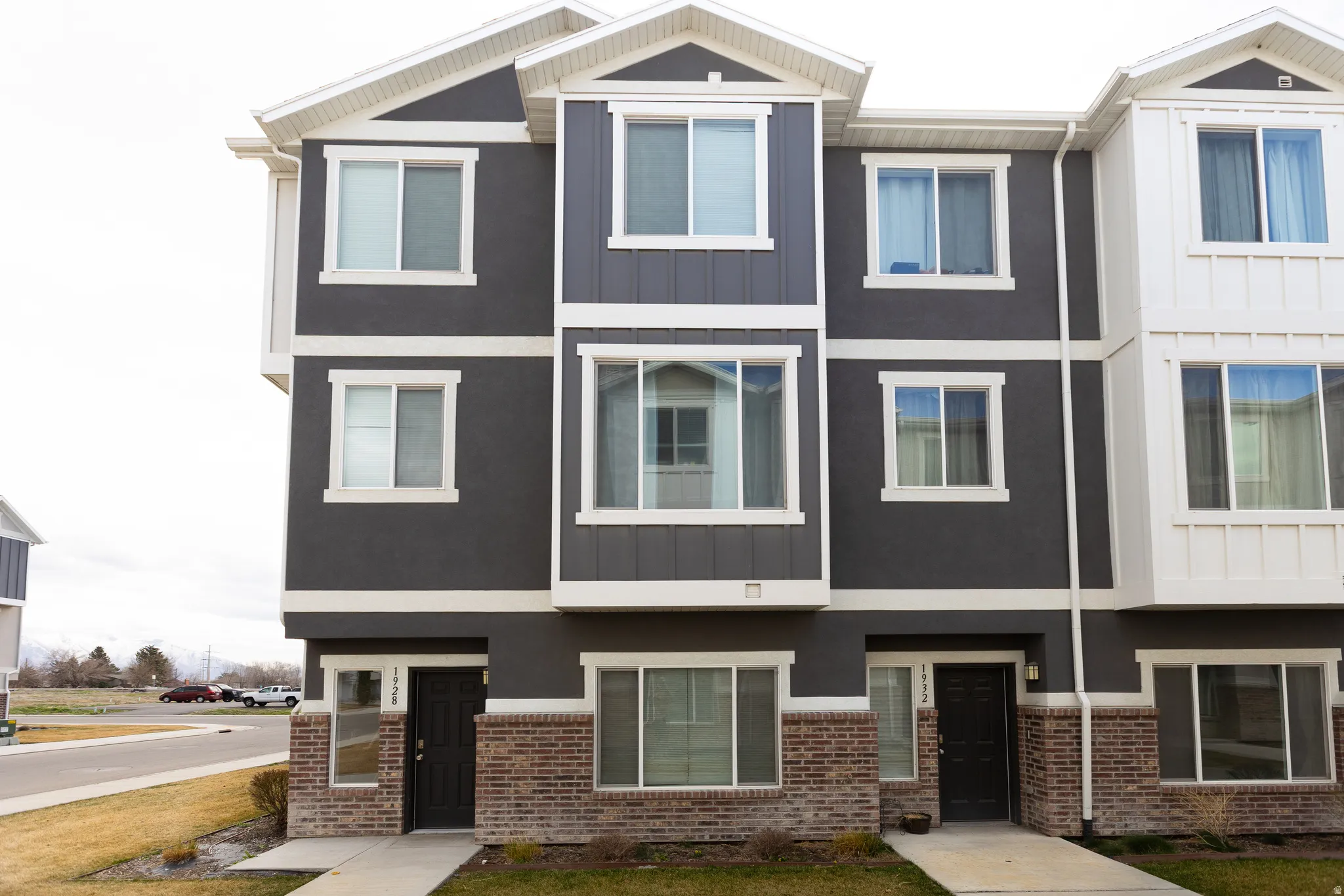 View of front of home featuring board and batten siding and brick siding