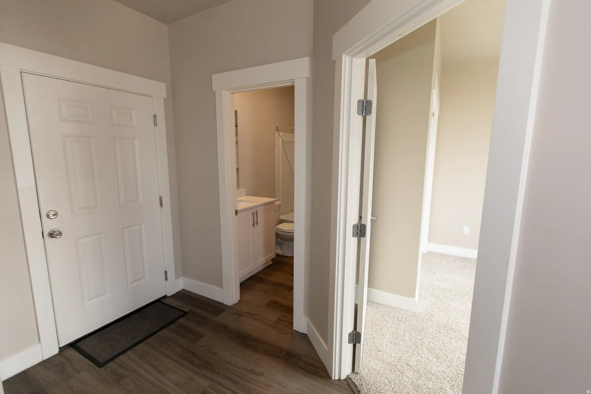 Hall featuring baseboards and dark wood-style floors
