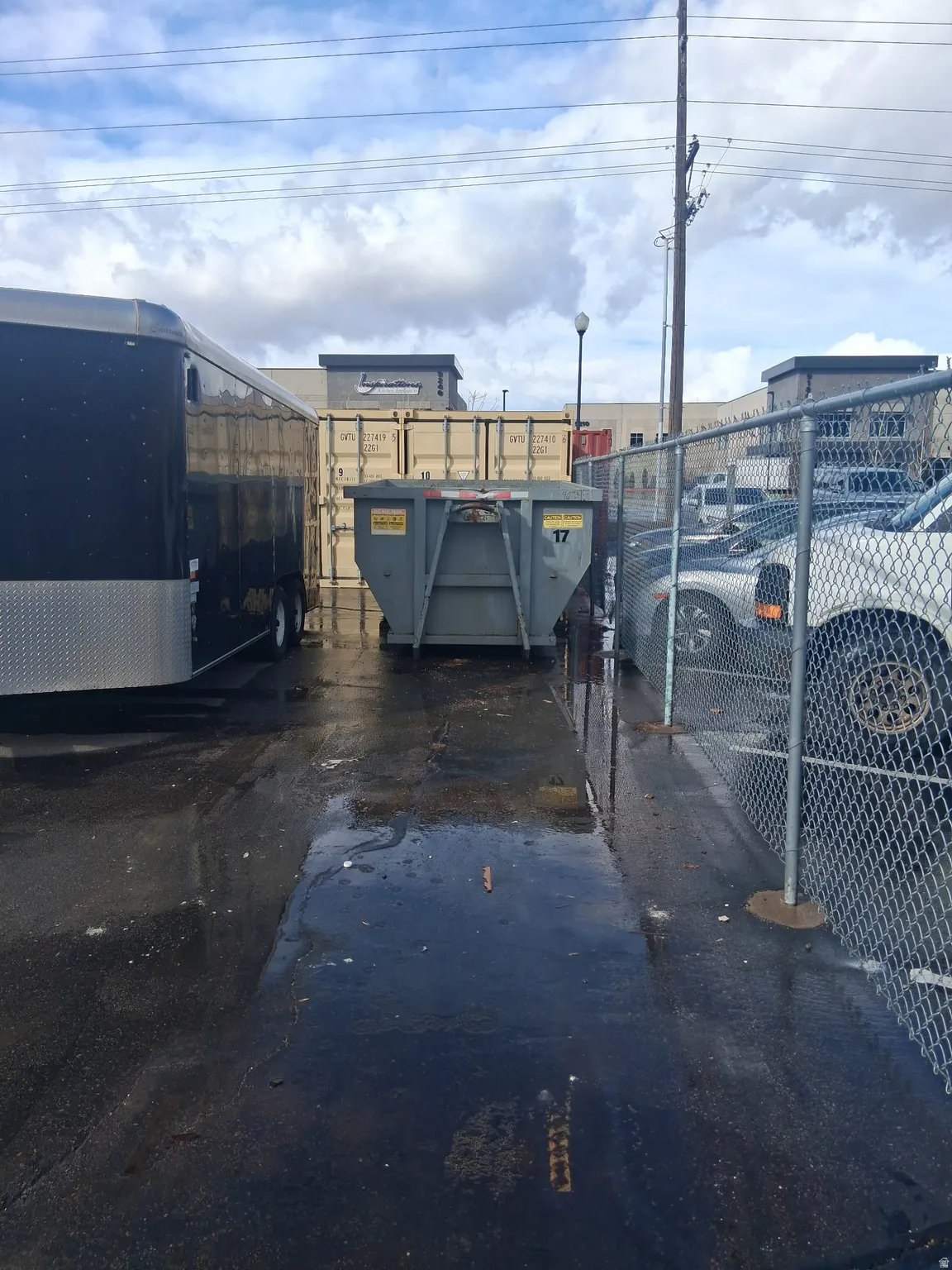 View of parking featuring a gate
