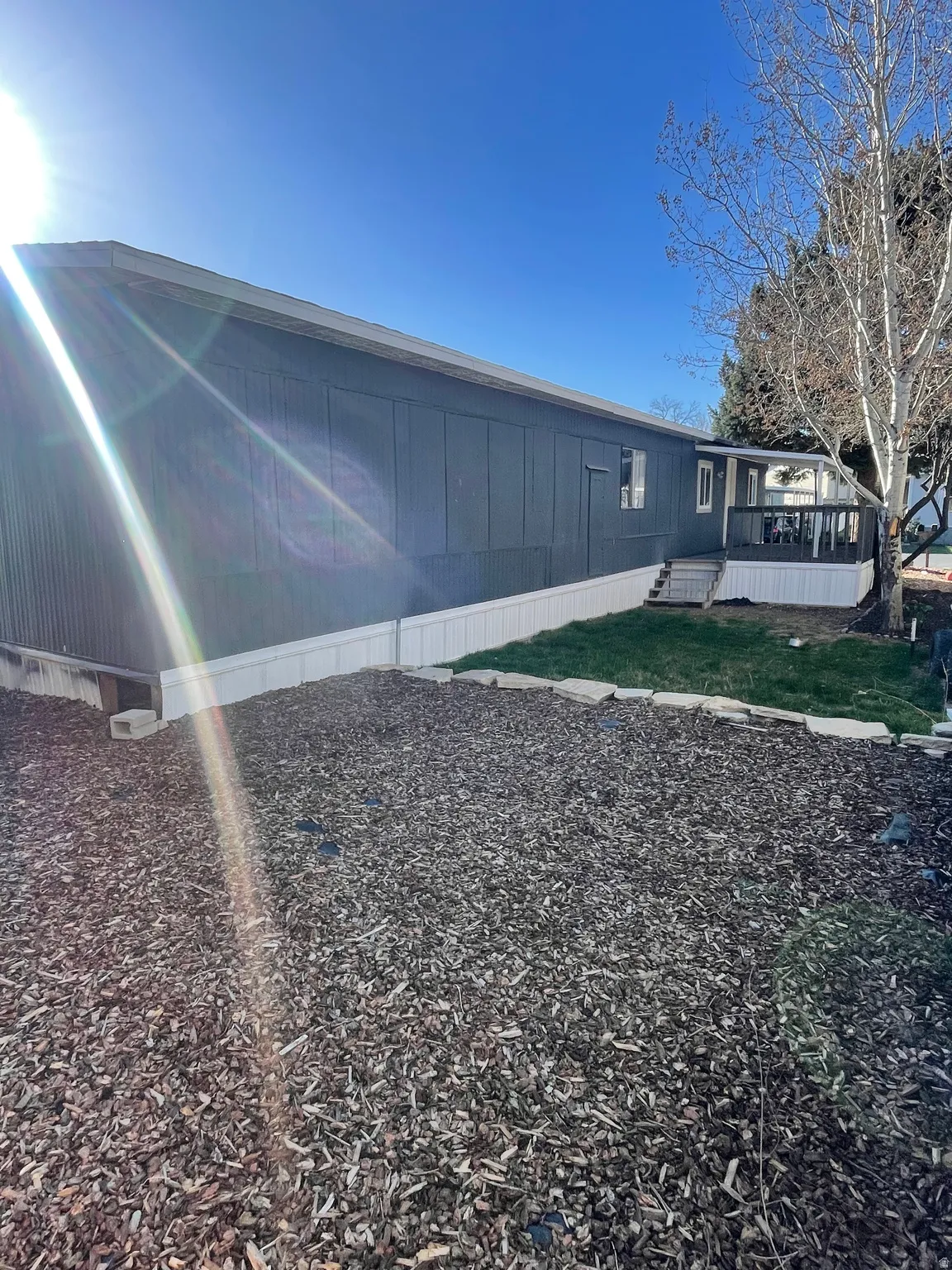 View of side of home with a deck