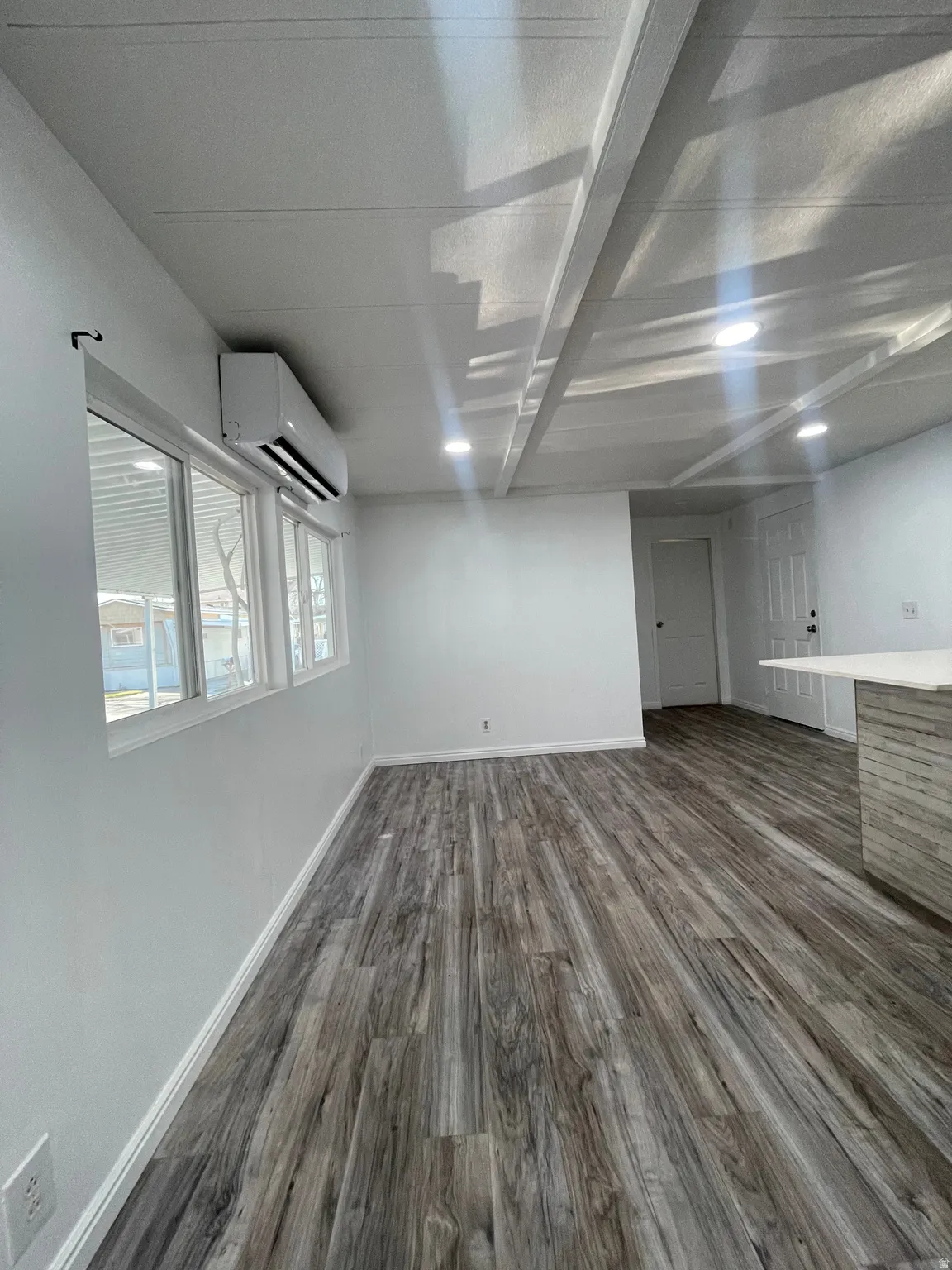Below grade area featuring dark wood-style flooring and a mini split for heating / cooling
