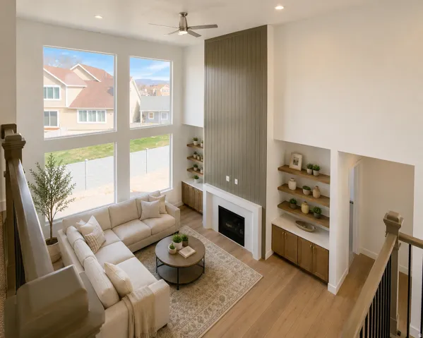 Virtually Staged...Two-story living area featuring a fireplace with a white mantel, vertical panel accent wall, and built-in shelving with lower cabinetry