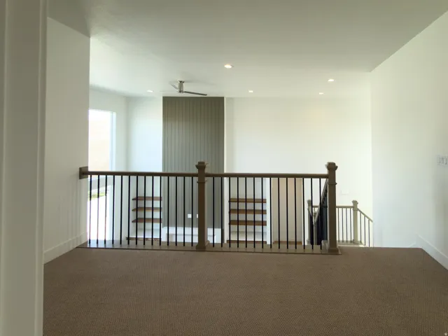 Hallway featuring an upstairs landing, carpet, and recessed lighting