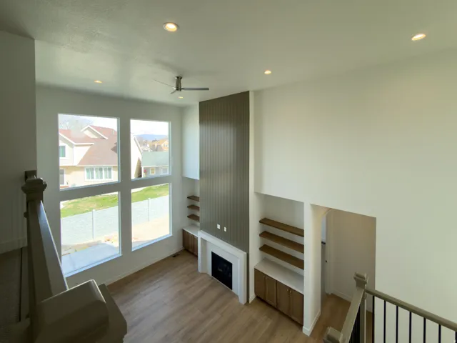 Living area featuring recessed lighting, wood finished floors, ceiling fan, and a fireplace