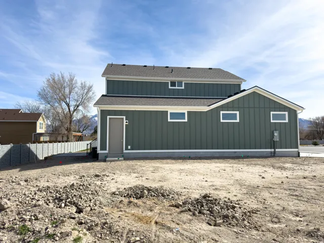 Side view  of house featuring board and batten siding and roof with shingles