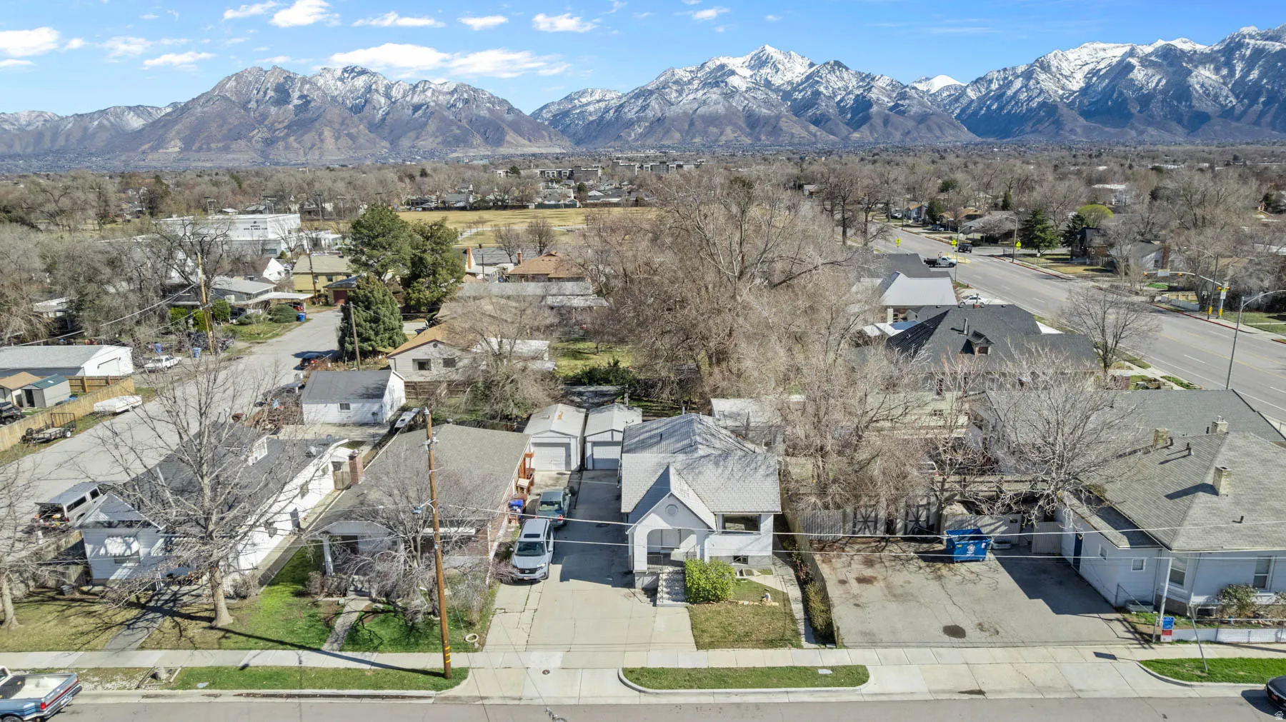 Aerial view showing proximity to Midvale City Park and the Wasatch Mountains