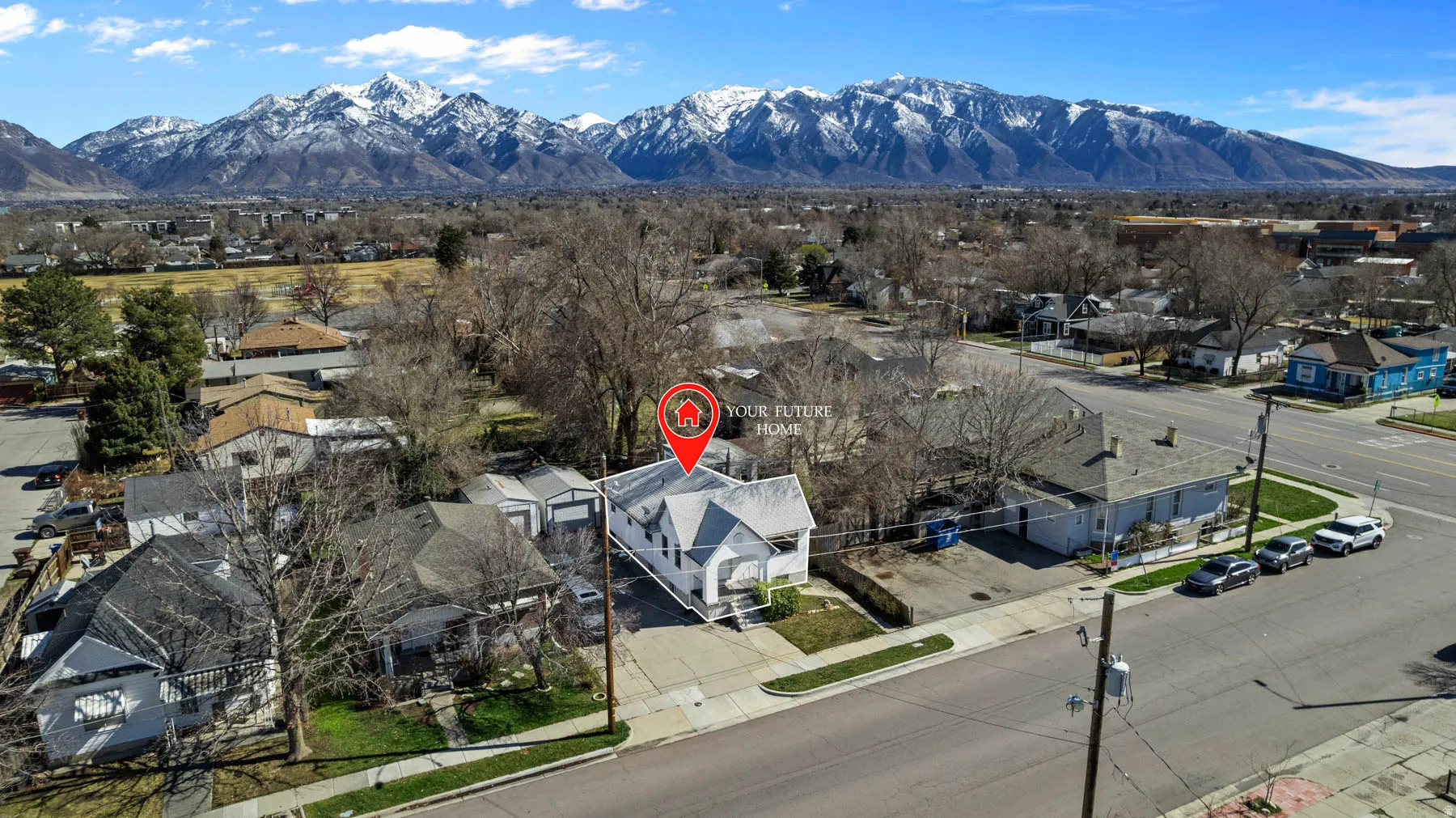 Aerial view showing proximity to Midvale City Park and the Wasatch Mountains