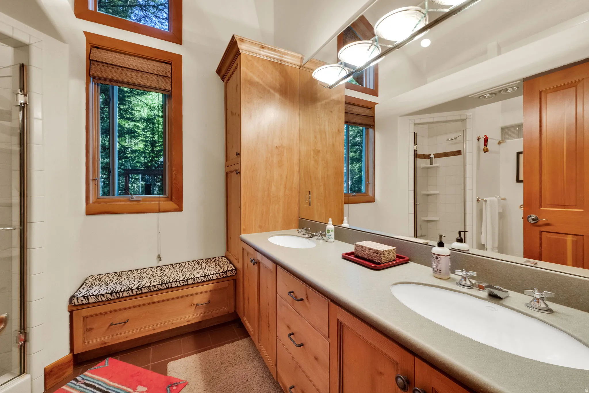 Dual vanity with integrated sinks and wood-finish cabinetry