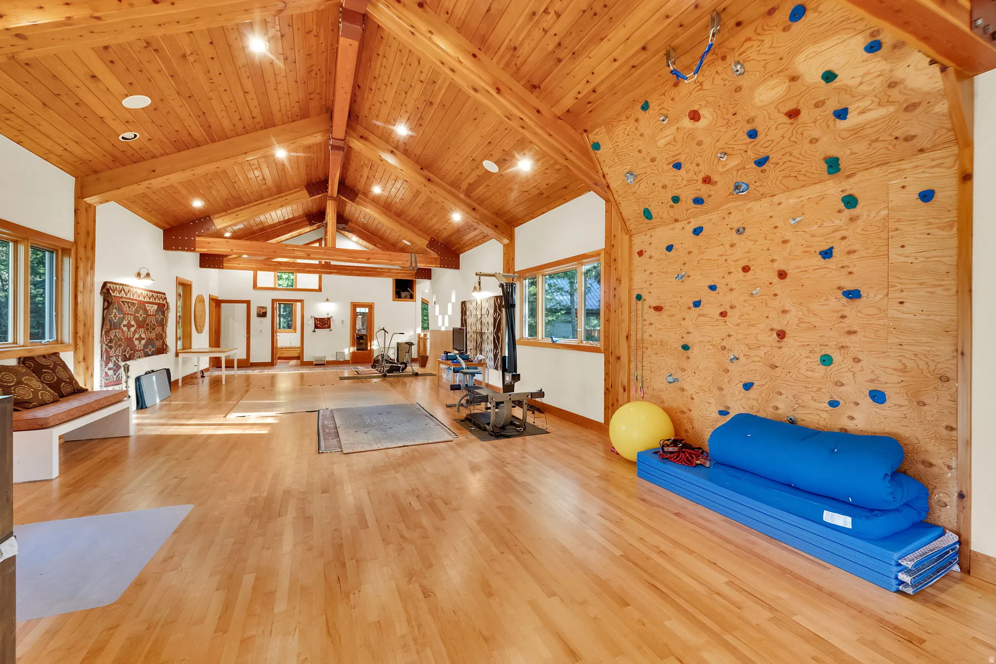 Vaulted wood-paneled ceiling with exposed beams and recessed lighting