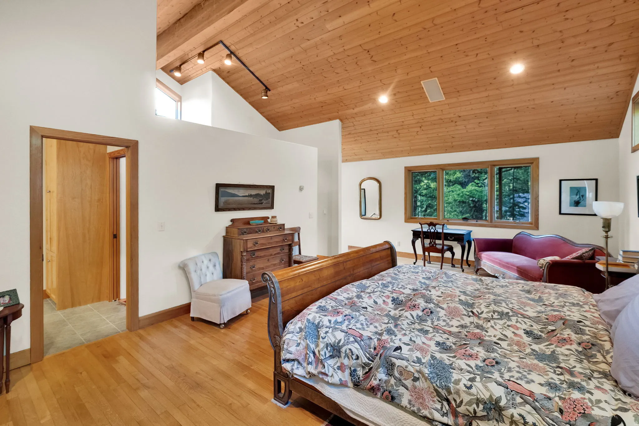 Vaulted wood-paneled ceiling with recessed lighting and track lighting
