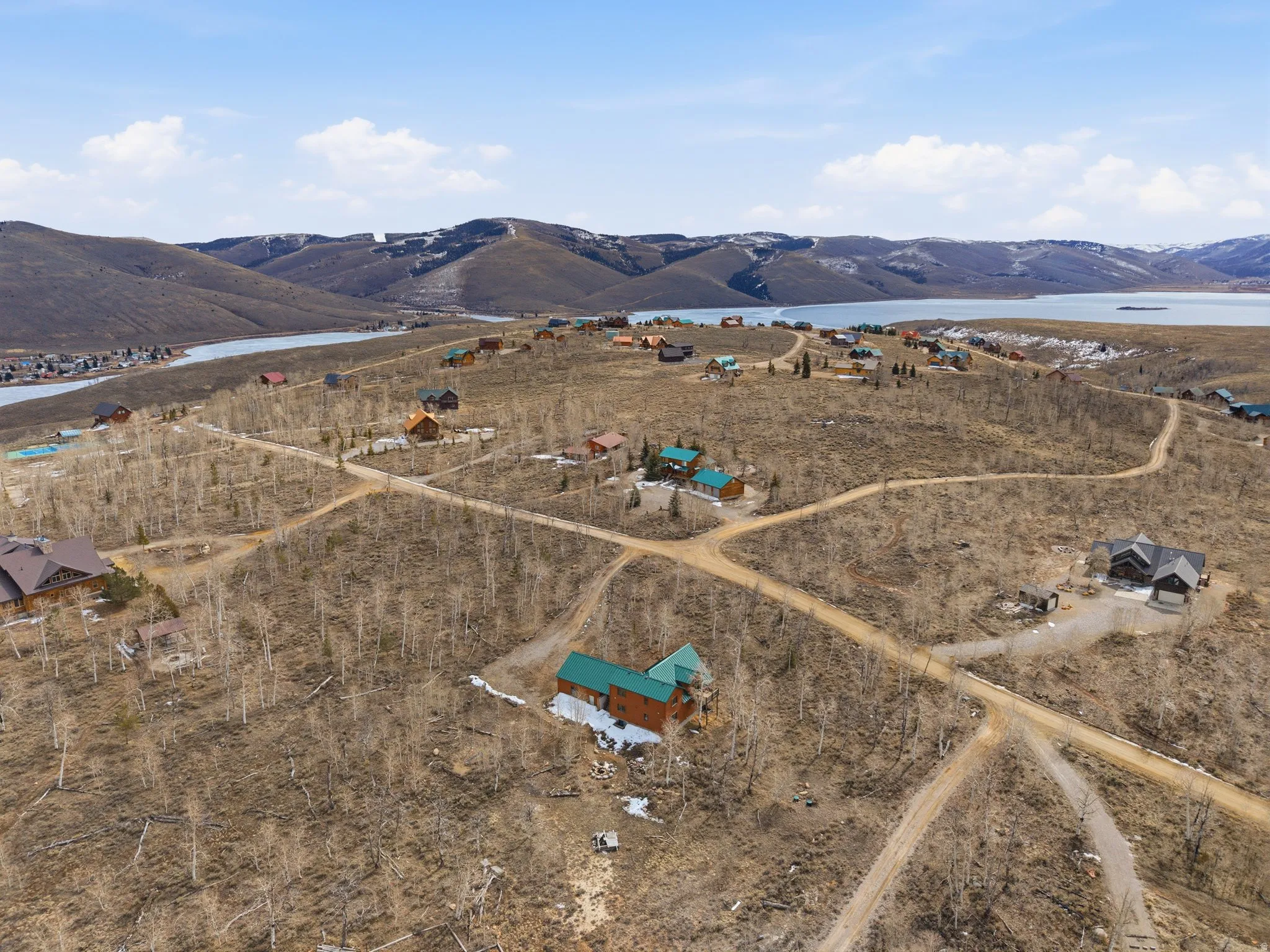 Aerial view of property's location with a water and mountain view