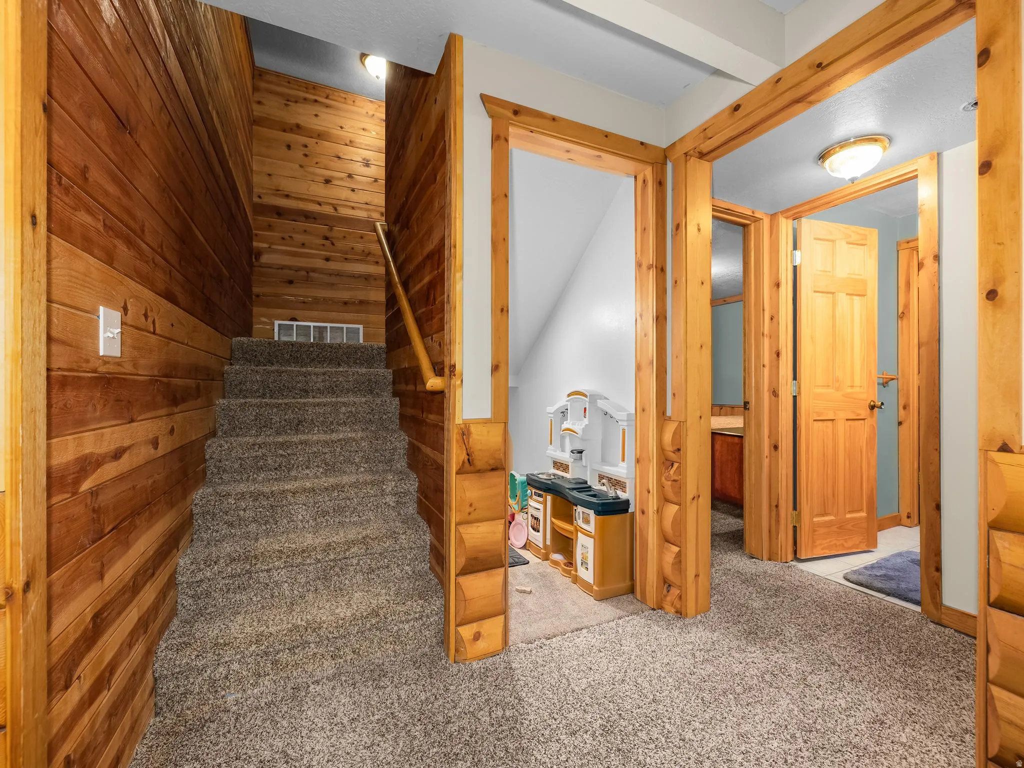 Stairway with wooden walls and carpet
