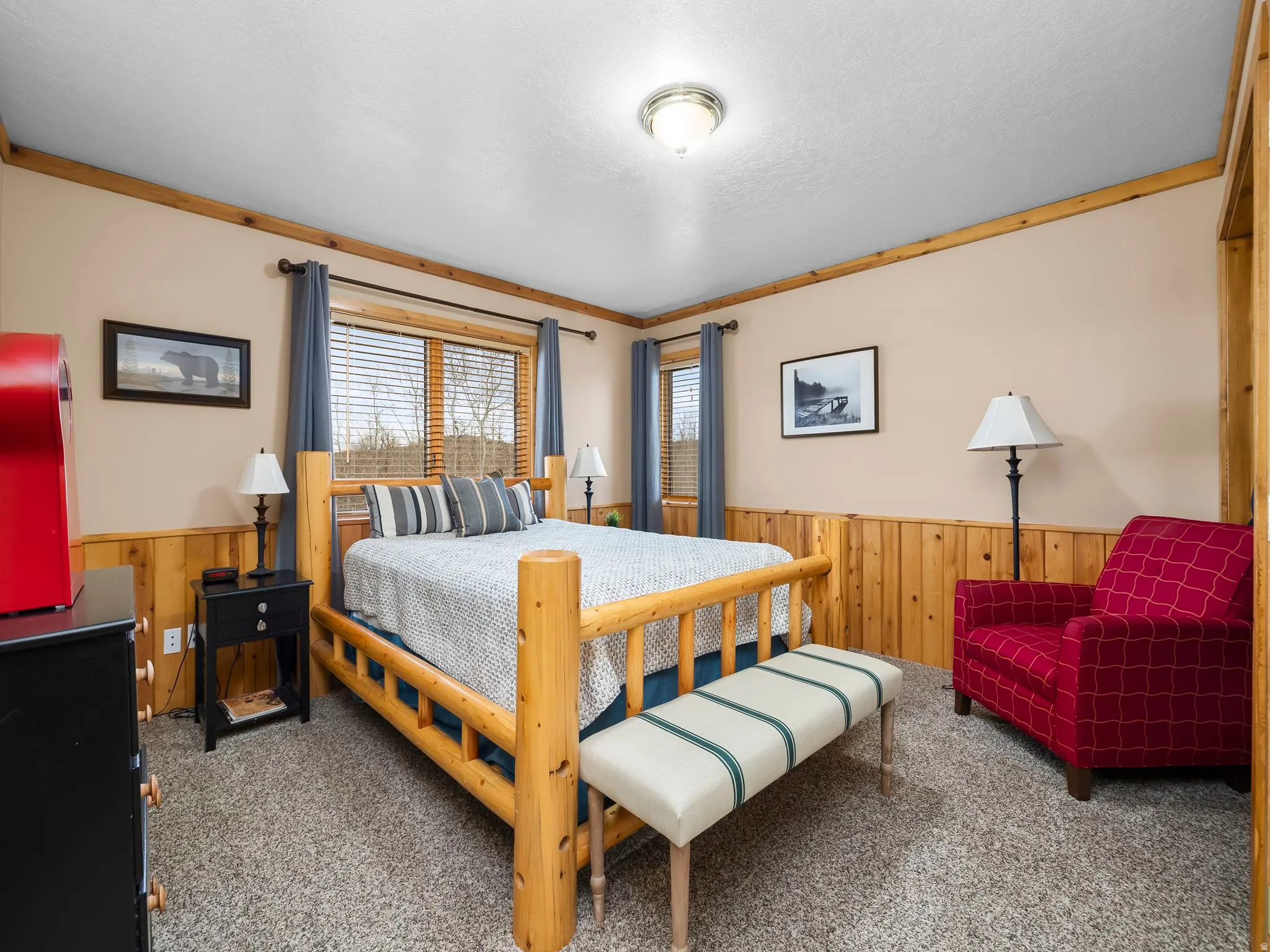 Bedroom with wooden walls, wainscoting, carpet, and crown molding