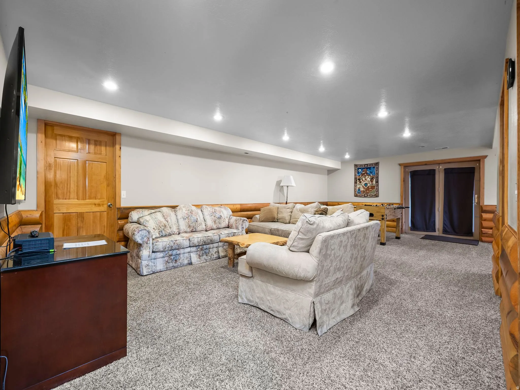 Living area with wainscoting, carpet floors, and recessed lighting