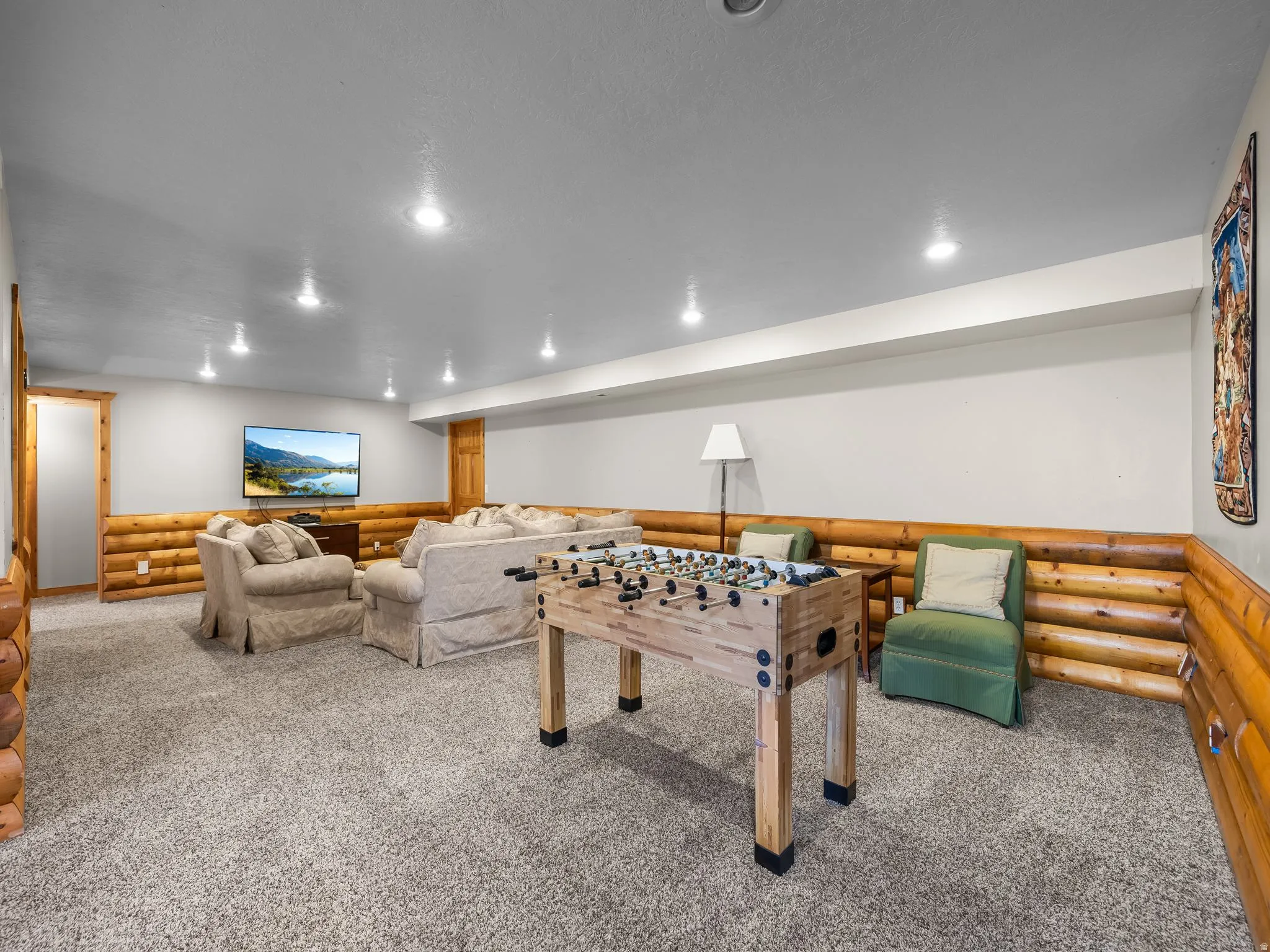 Rec room featuring carpet flooring, recessed lighting, and wainscoting