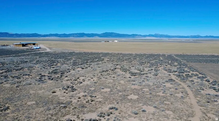 View of mountain backdrop with a desert landscape and rural landscape