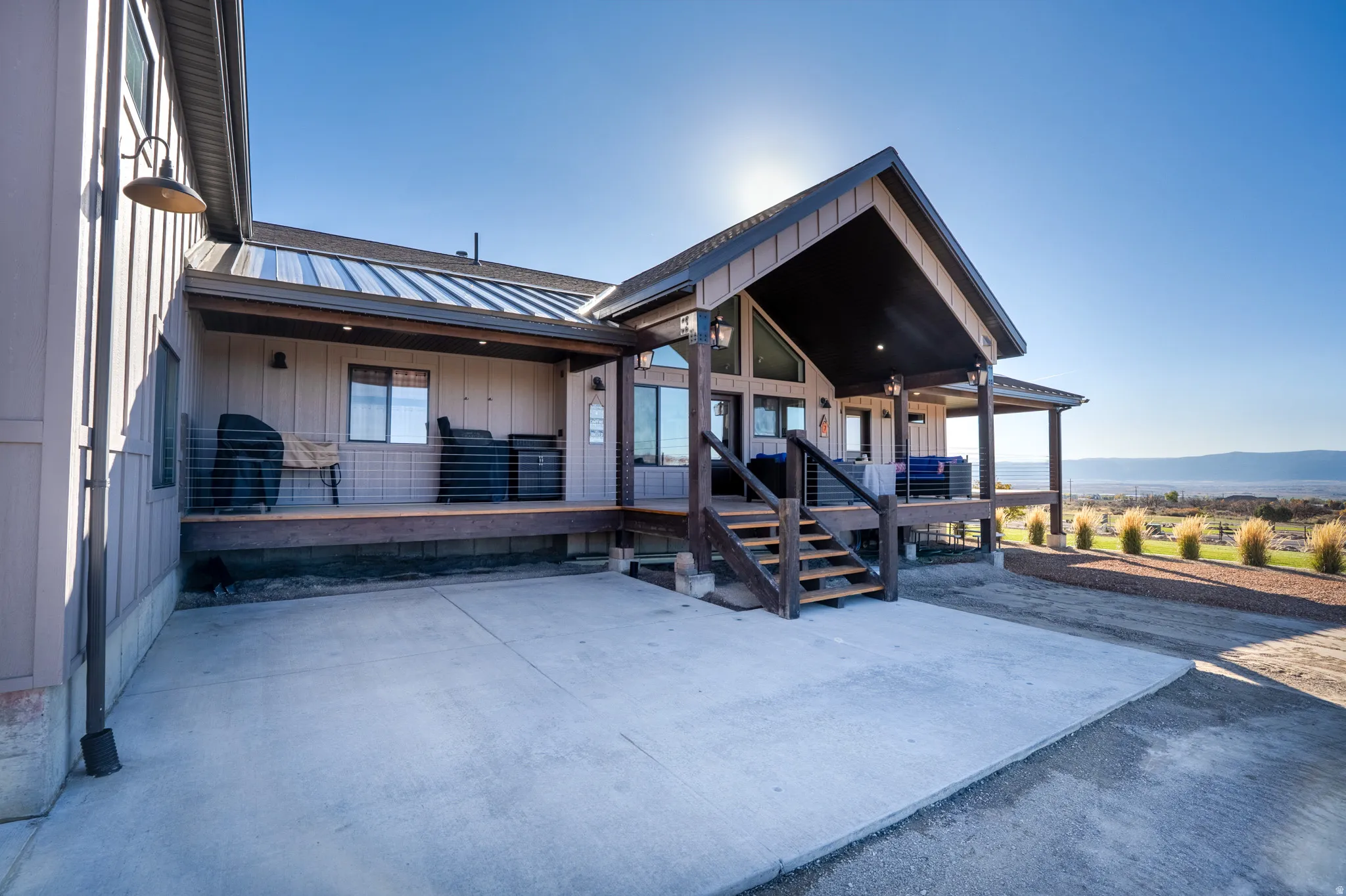 Doorway to property featuring a patio area, a standing seam roof, a mountain view, and board and batten siding