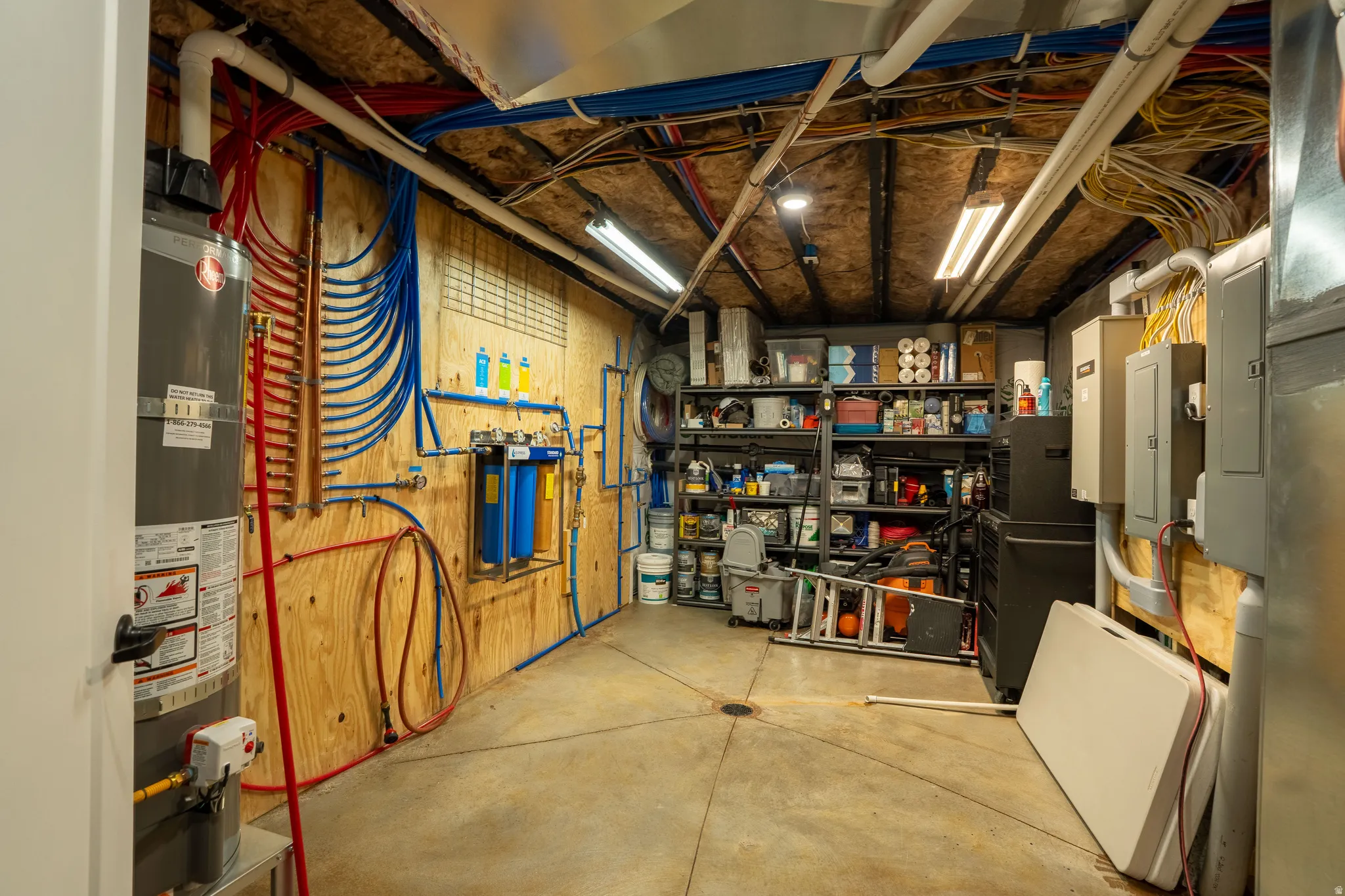 Storage featuring electric panel and water heater, plumbing
