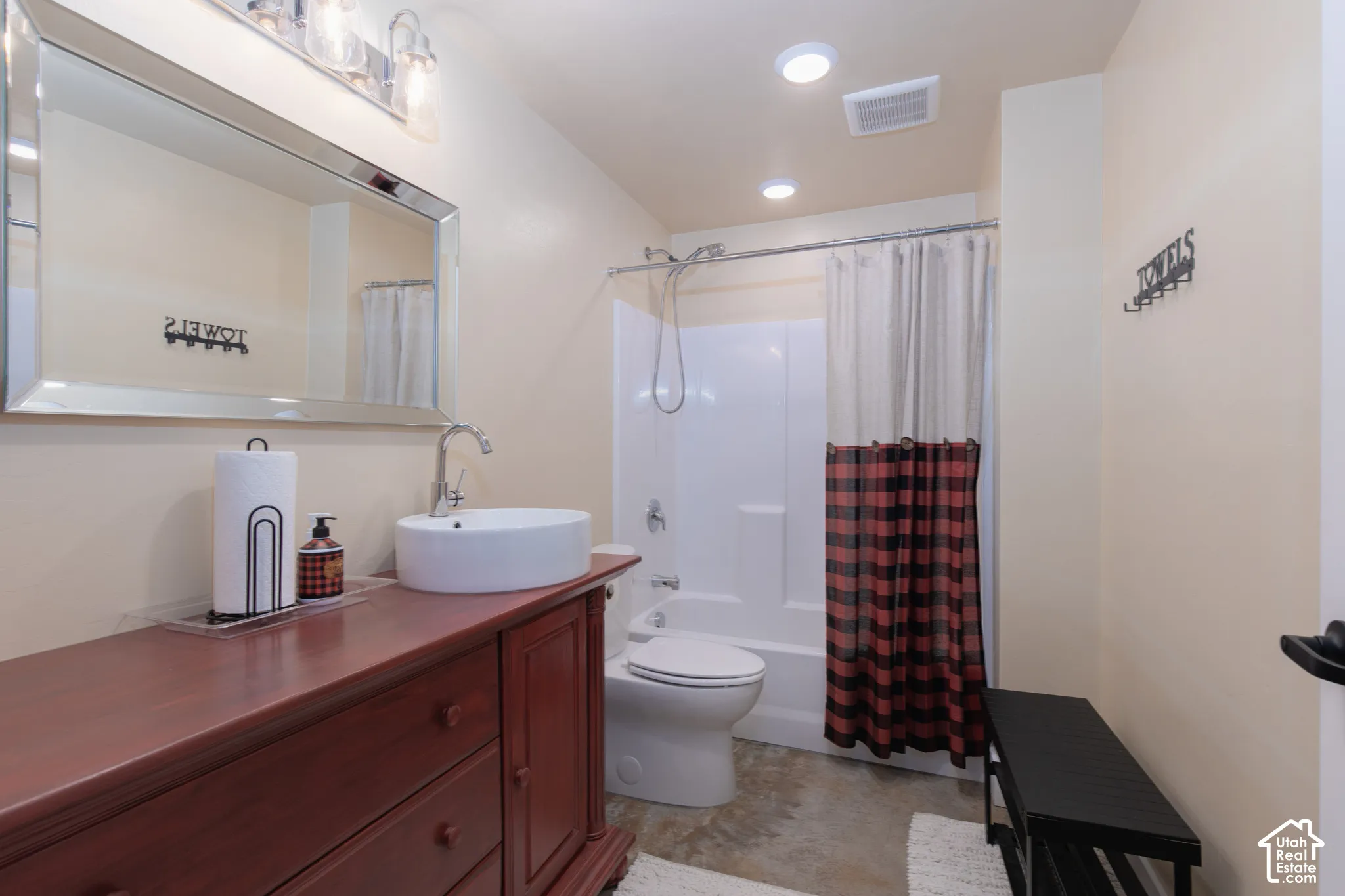 Vanity with a vessel sink, chrome faucet, and a large framed mirror
