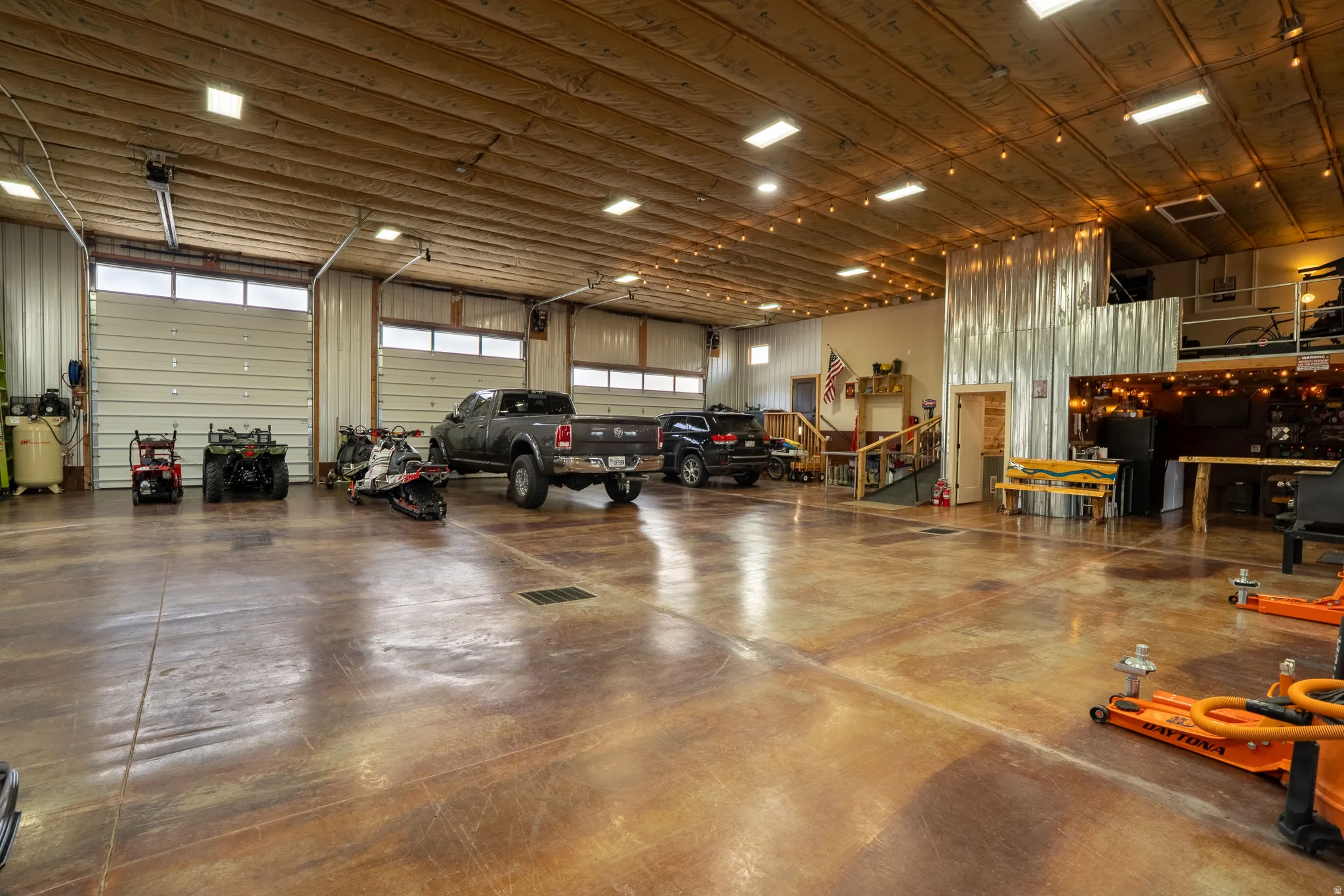 Garage featuring metal walls, tall ceilings