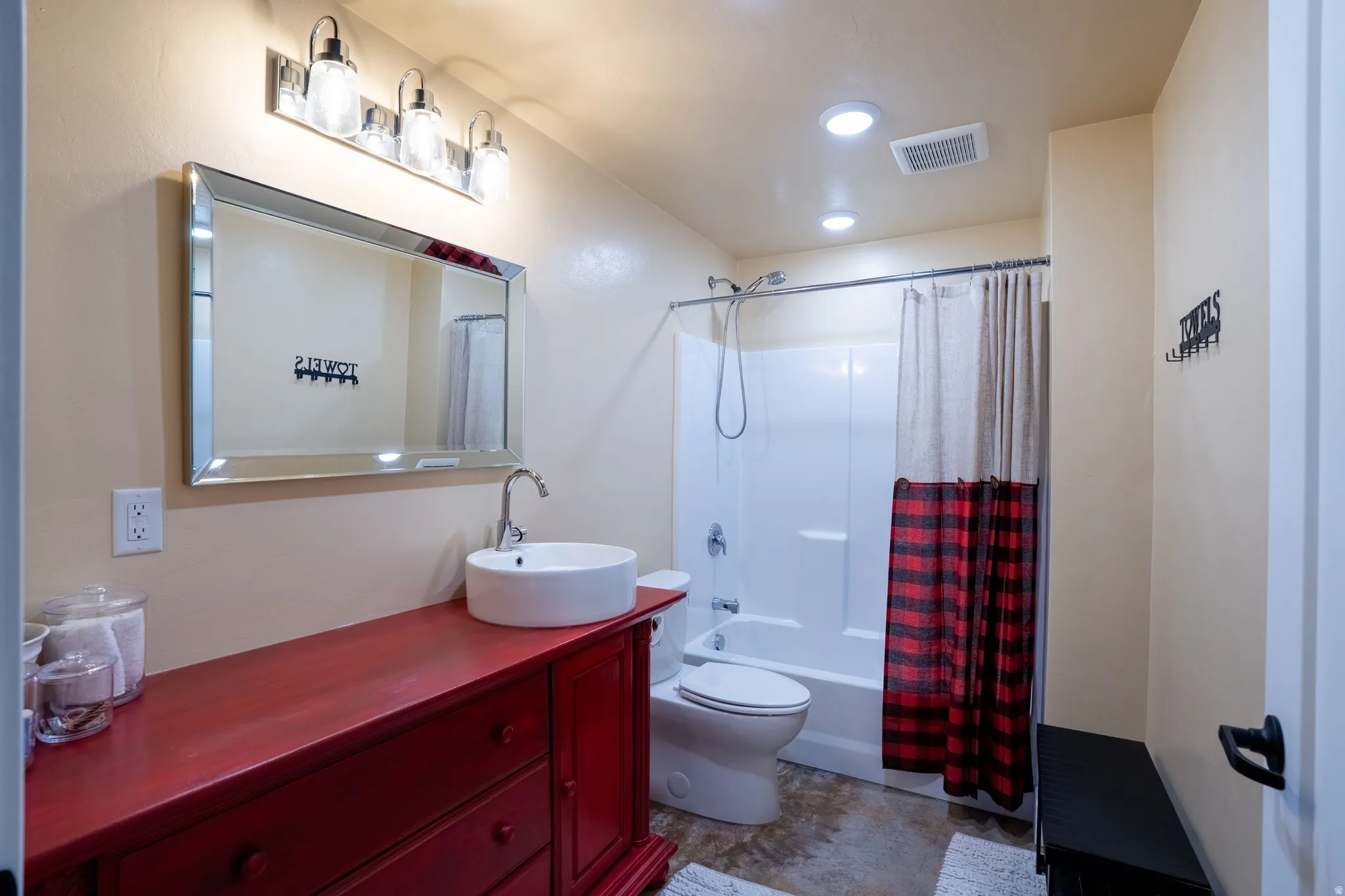 Bathroom featuring vanity and shower / tub combo with curtain