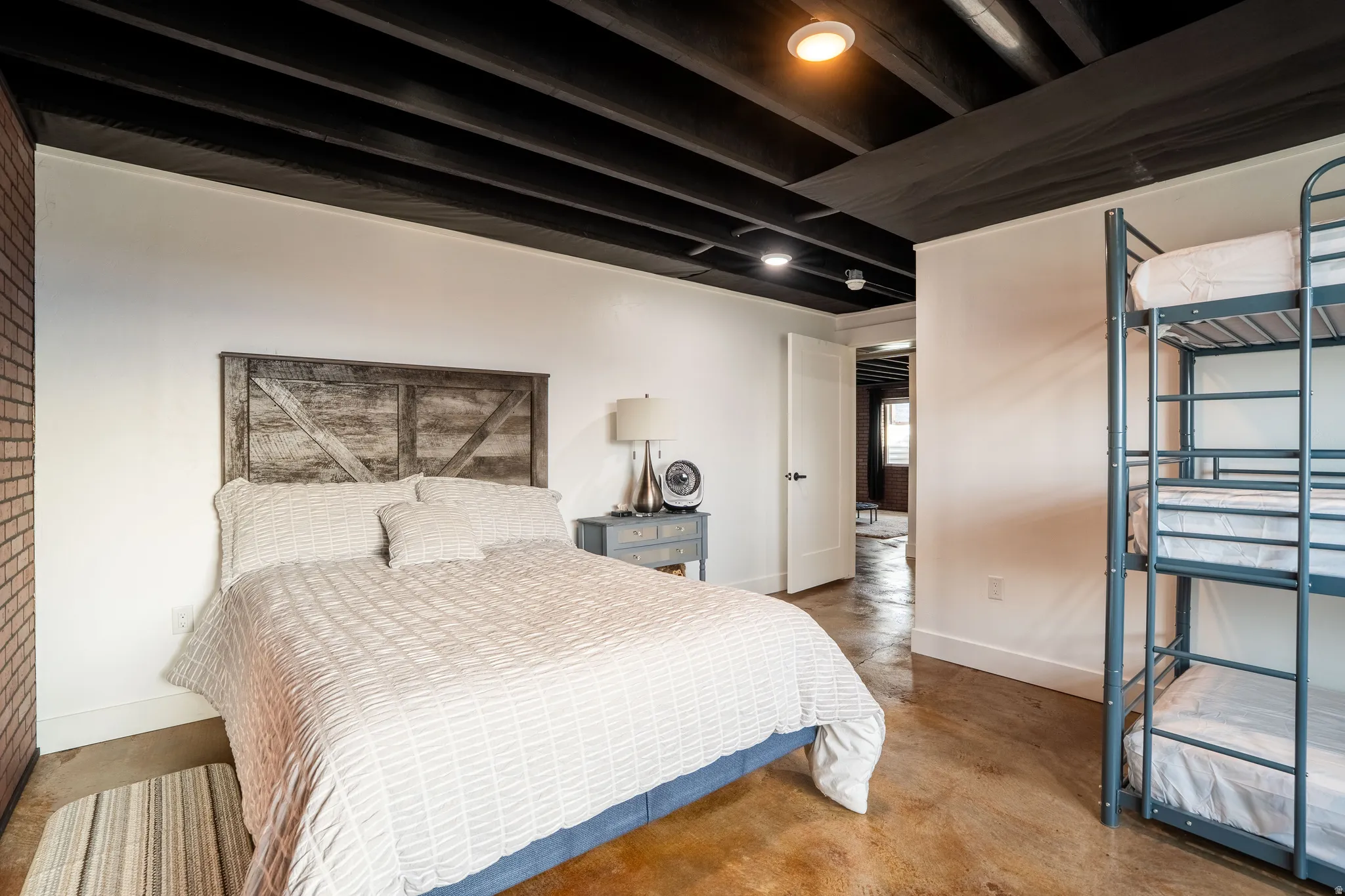Bedroom 4 featuring finished concrete flooring and recessed lighting